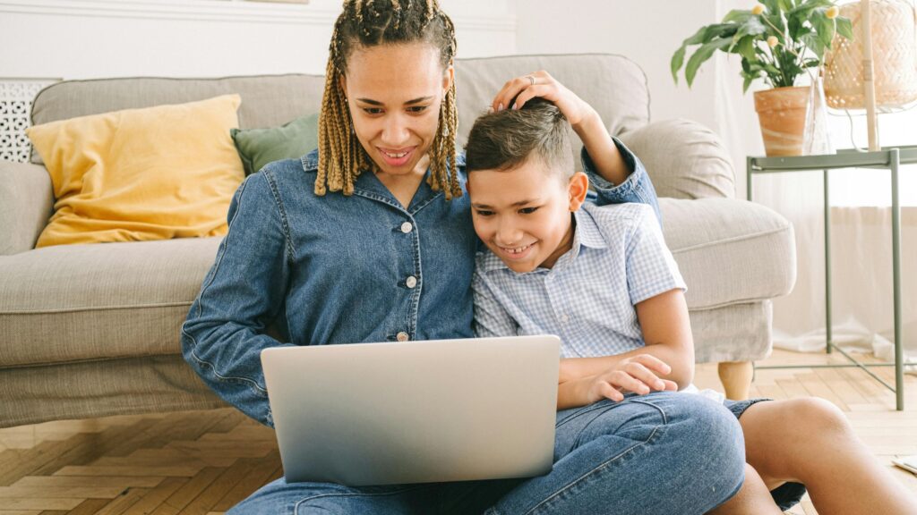A parent and child on an online speech therapy call; SoundEd Therapy for Kids