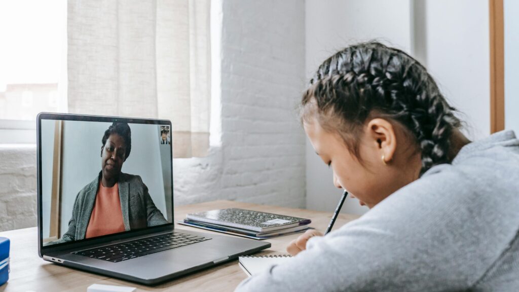 a child on a school-based teletherapy call; SoundEd Therapy for schools