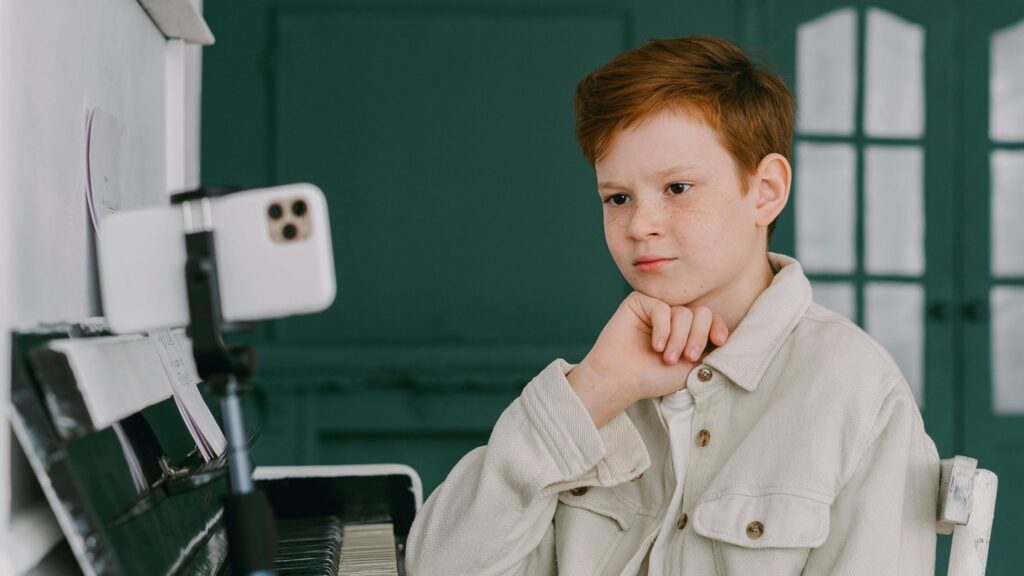 A student posing for a picture in school; SoundEd therapy onboarding teletherapy in schools